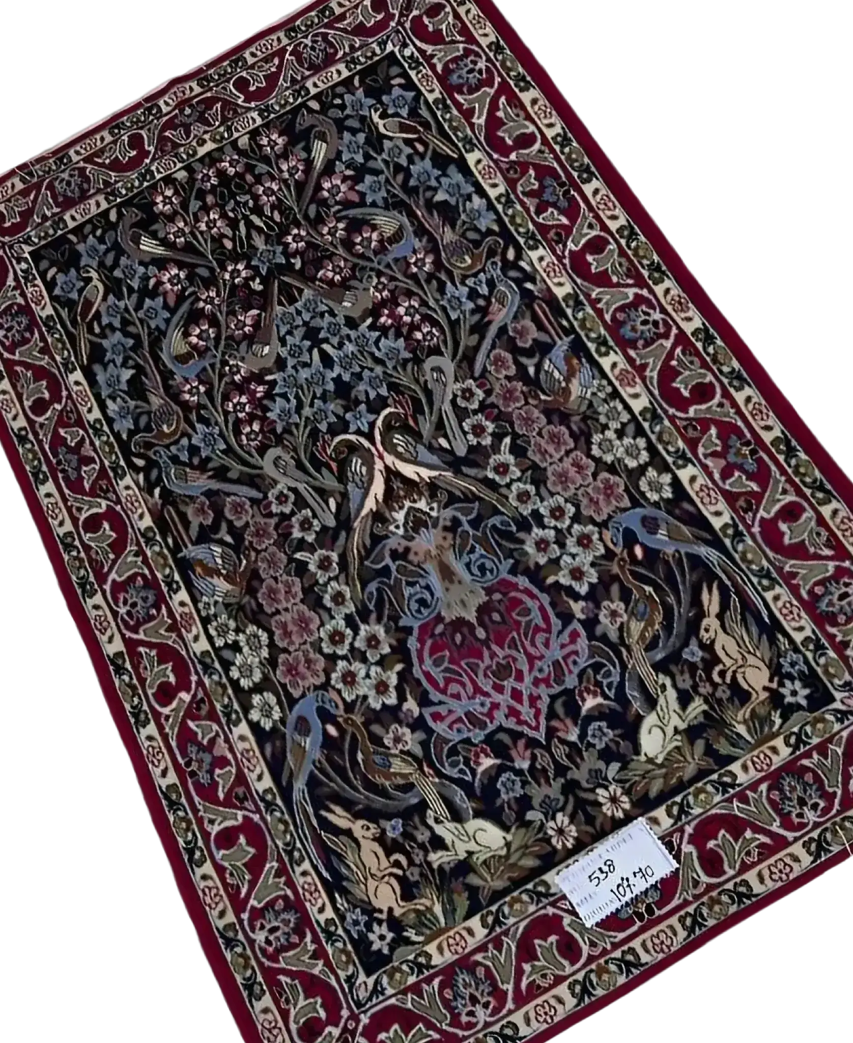 "Elegant handmade Isfahan rug featuring intricate Persian motifs, crafted from wool and silk. The rug measures 107 cm x 70 cm (3.5 x 2.3 feet) and showcases delicate craftsmanship with a soft texture and luxurious feel. A beautiful addition to luxury home décor."